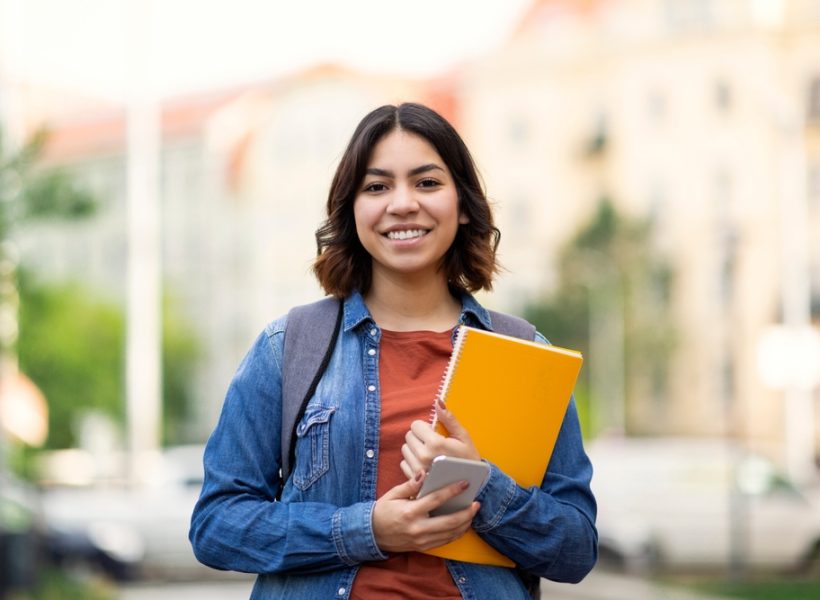 Beautiful,Young,Arab,Female,Student,Standing,Outdoors,With,Workbooks,In